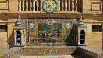 Coat of arms and decorative mosaic on a historic building in Seville