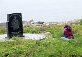 woman with camera near grave monument