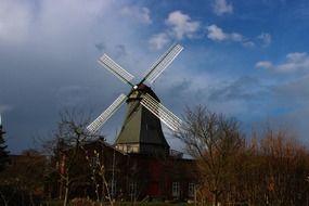 windmill building on beautiful autumn scene among the plants