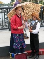 girl playing flute on the street