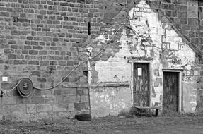 old house with brick walls on black and white image