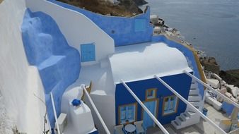 white and blue house on santorini island in greece