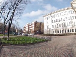 white building, parked cars and pavement