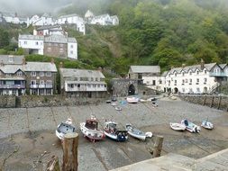 boats in front of village on mountain side, uk, england, cornwall, clovelly