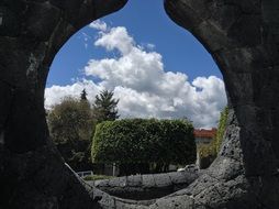 garden view from a hole in the wall