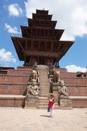 woman posing in front of ancient Buddhist temple