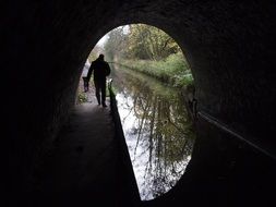 man goes to the tunnel near the canal