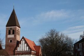 church with a spire among the trees