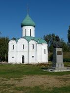 old church with green dome in park at sumer, russia, pereslawl