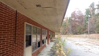 old abandoned red brick building with broken windows