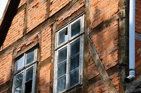 old brick building with broken window