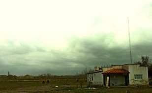 landscape of farm under stormy clouds