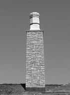 Black and white photo of the brick fireplace on the roof