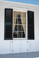 black shutters on white window