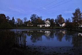 landscape of pond in village at dusk