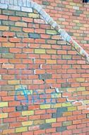 Wall with graffiti and colorful bricks on it