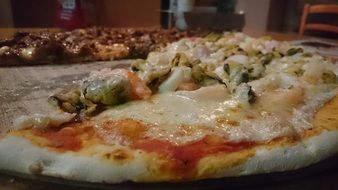 Tasty pizza with seafood and cheese on it