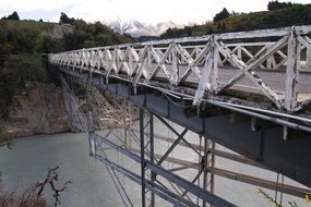 metal bridge over the river in new zealand