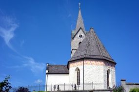 old church with clock tower on a background of blue sky