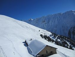 snow-covered house among high mountains