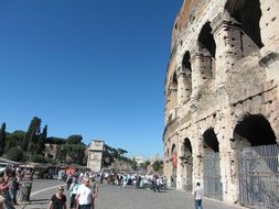 Groups of tourists by colosseum in Rome in Italy