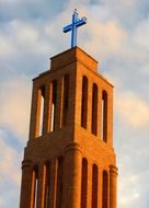 blue cross on brick church