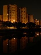 apartment buildings near the water in bratislava at night