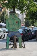 hulk, ugly figure on sidewalk in city