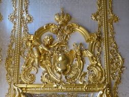 Gold decor of the wall of the Catherine Palace in St. Petersburg