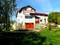 home landscape white house with red doors