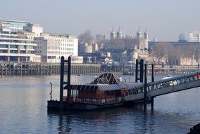 boat landing in view of city, uk, england, london