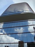 skyscraper with reflection of clouds on facade, brazil