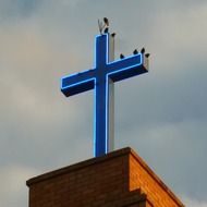 birds on the blue cross on the roof