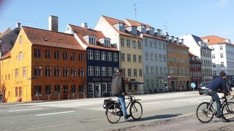 men ride bicycles in old city