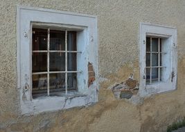 facade of an old building with bars on the windows close-up