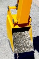 yellow shovel with pebbles