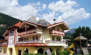modern house with a playground on a background of mountains in Italy