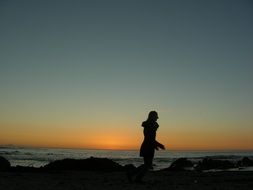 woman on the beach at sunset in africa