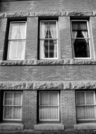 black and white photo of a brick building with windows