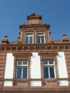 the facade of the historical building is brown with white