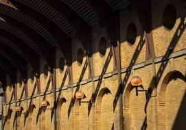 brick wall with lamps under the bright sun