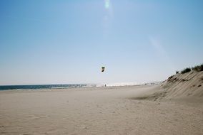landscape of kitesurfer on sea at empty beach
