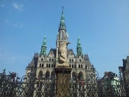 beautiful old building of city hall behind wrought iron fence, czech republic, liberec