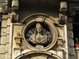 bust on the facade of the building