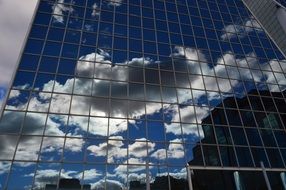 Reflection of clouds in the glass facade of the building