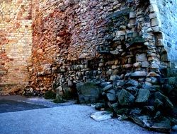 Old stone wall in different colors in the light and shadow