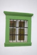 green window on a house wall