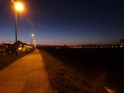 empty road at night in the light of lanterns