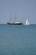 three-masted ship and white boat in the Mediterranean