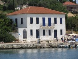 white building in port among the plants in Greece